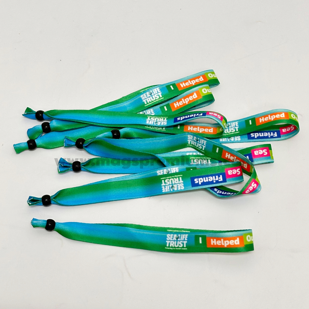 Custom printed fabric wristbands with full-color gradient design and adjustable locking beads, suitable for event admission, festivals, fundraising campaigns, concerts, and brand promotions.