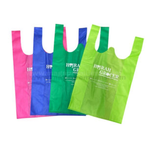 Custom non woven singlet bags in pink, blue, green, and light green colors with white logo printing, reusable shopping bag design, and lightweight eco-friendly material for retail and promotional use.