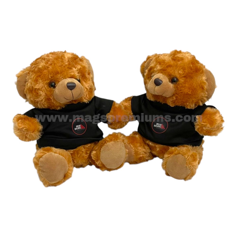 Soft brown plush teddy bears wearing branded black T-shirts, custom manufactured for promotional gifts, employee appreciation, and retail merchandise.