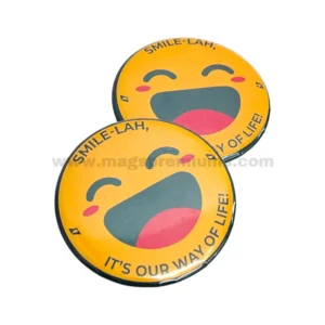 Custom button badges with cheerful yellow emoji face design and full-color printing, featuring a motivational slogan on round promotional badges suitable for events, campaigns, and corporate giveaways.