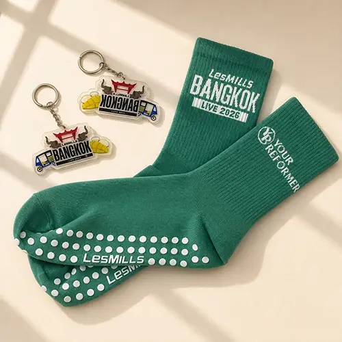 Custom grip socks with logo embroidery and promotional keychains for sports events, fitness studios and corporate giveaways.