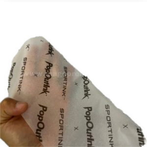 Printed tissue packaging paper sheets shown by hand
