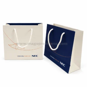 Custom made paper bags with rope handles and printed company logo in navy and cream