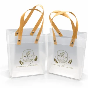 Frosted PVC tote bags with wooden handles and custom gold logo print, Wild Kombucha