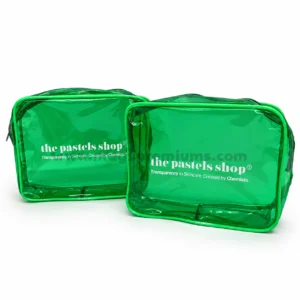 Two green tinted PVC makeup bags with zip top, printed with a skincare brand logo in white